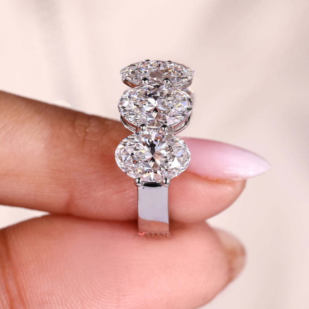 Shared prong wedding band with oval cut diamonds.