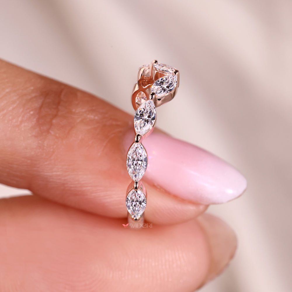 Curved wedding band with shared prong diamonds.
