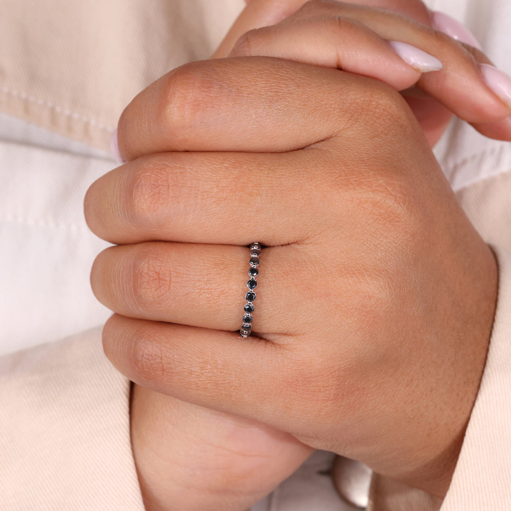 Moissanite anniversary band featuring round diamonds set in a shared prong band.