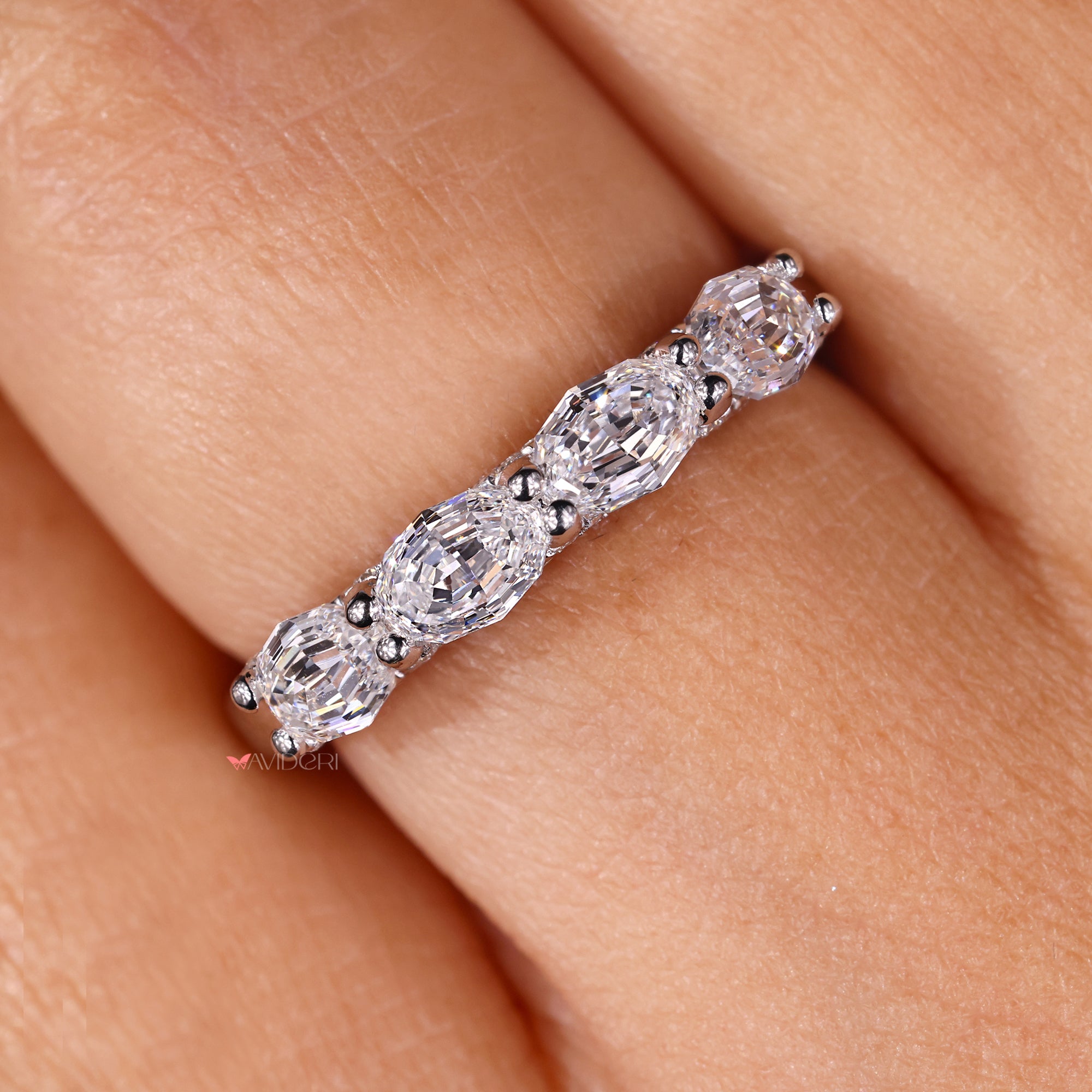 Oval step cut band in shared prong wedding band.