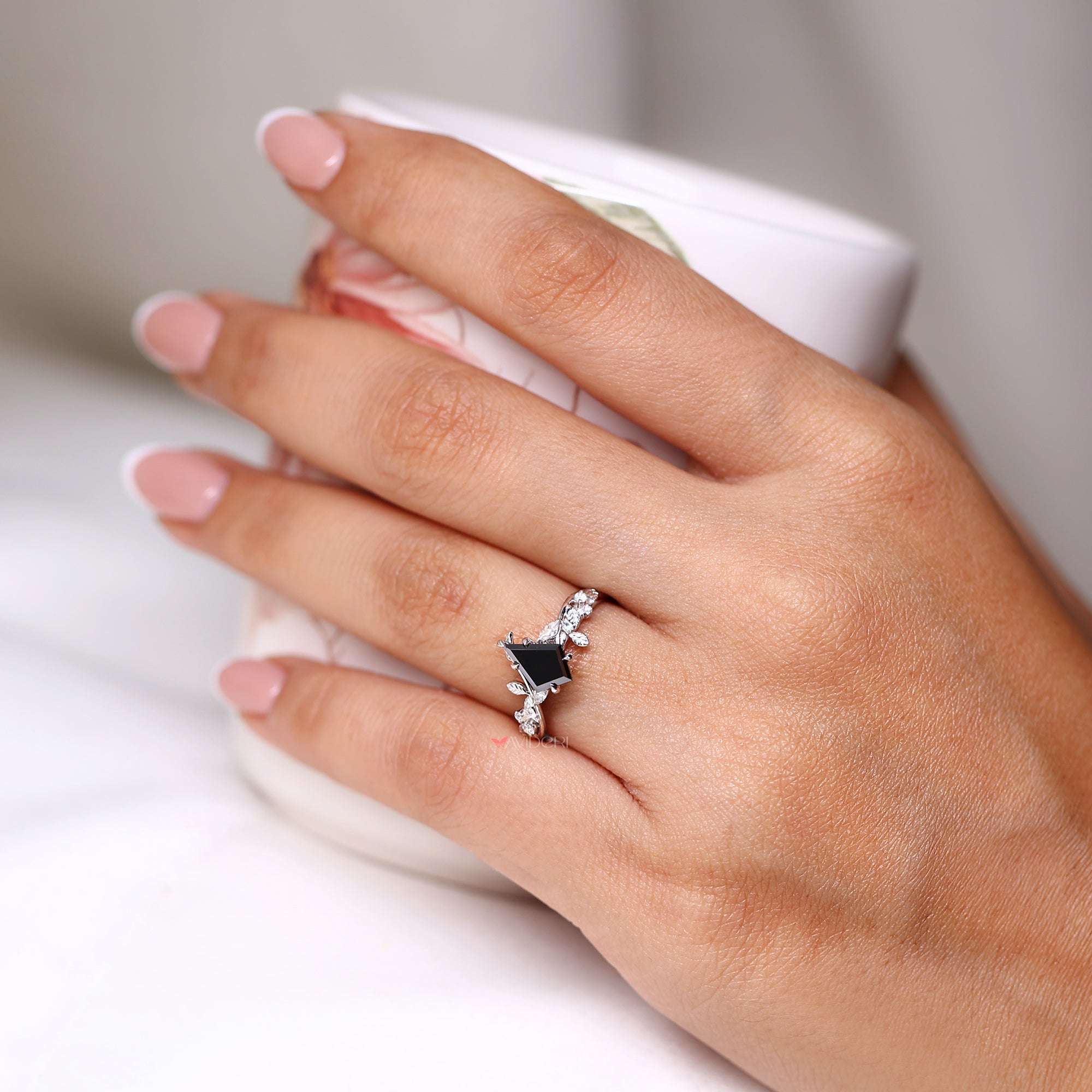 Round and marquise side stone ring in white gold.