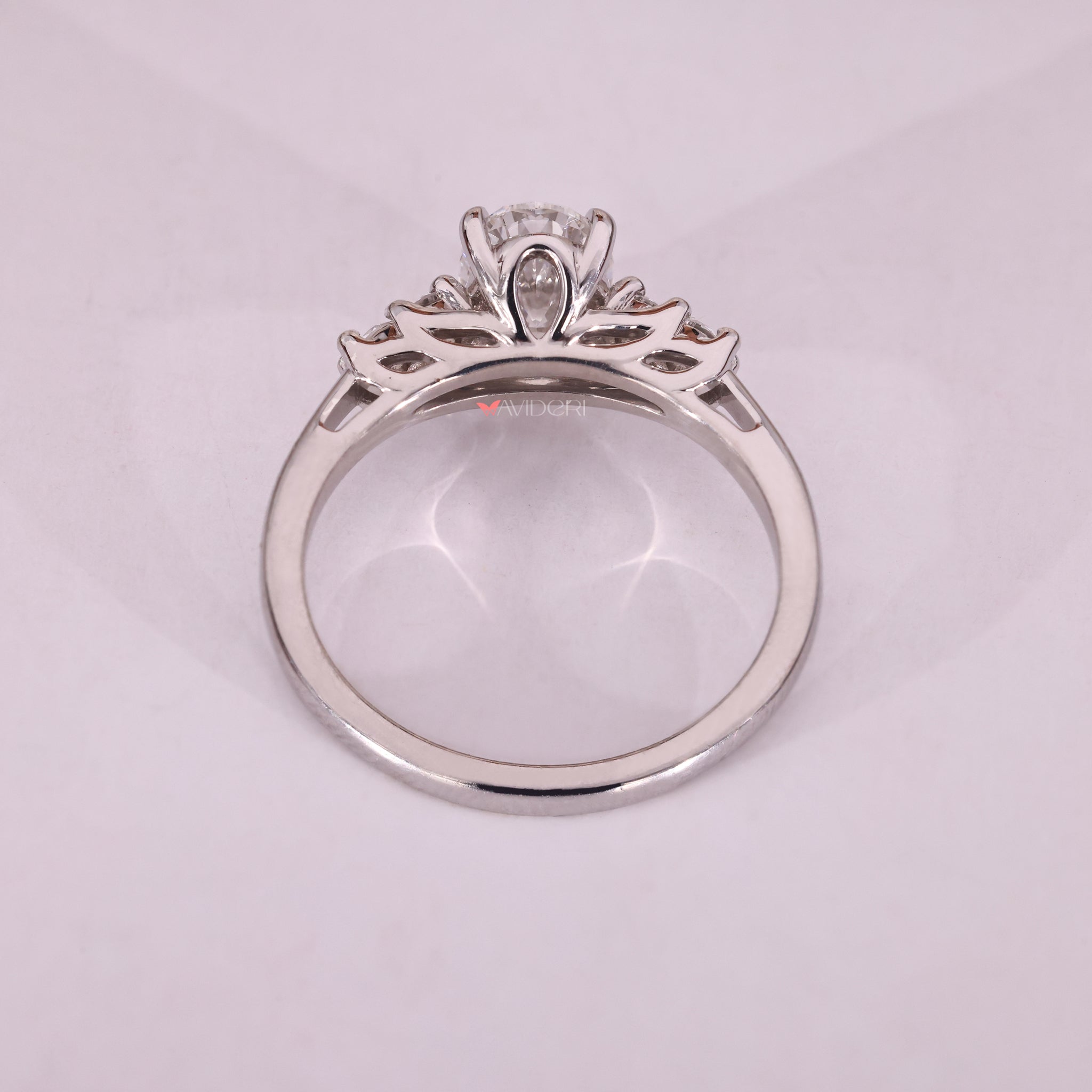 Round cut side diamond engagement ring offers a soft contrast to the oval center.
