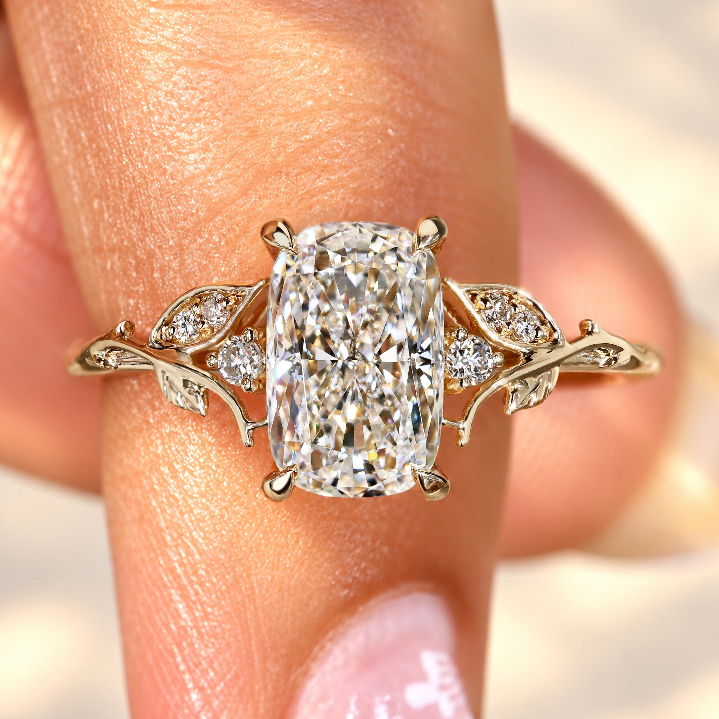 Cushion cut diamond ring with round side stones.
