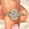 Cushion cut diamond ring with round side stones.
