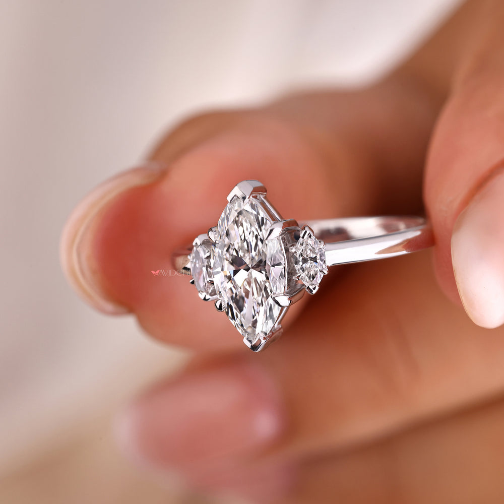 Marquise cut diamond ring with 3 stone marquise engagement ring accents, combining elegance and sparkle.
