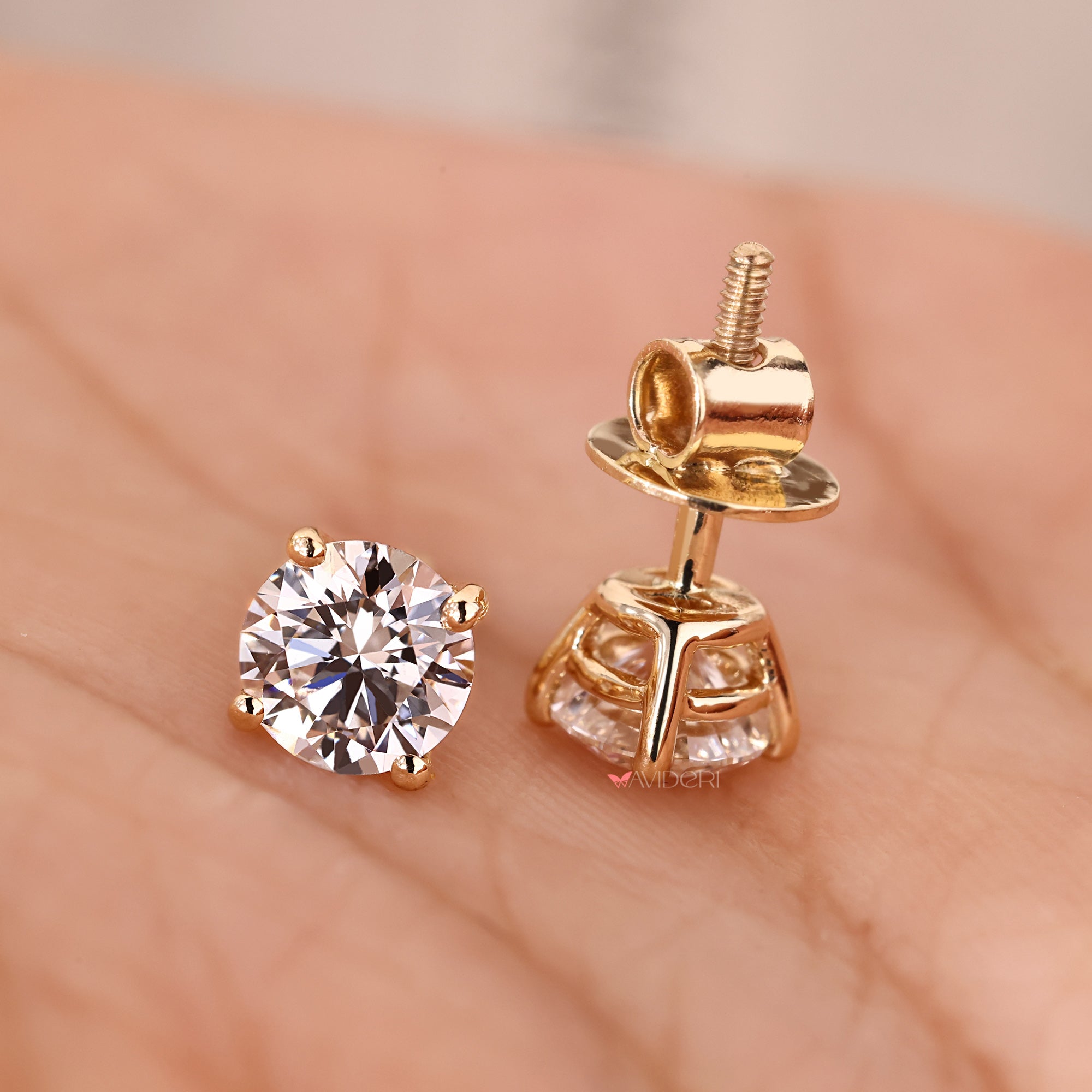 Diamond stud earrings with screw back closure.