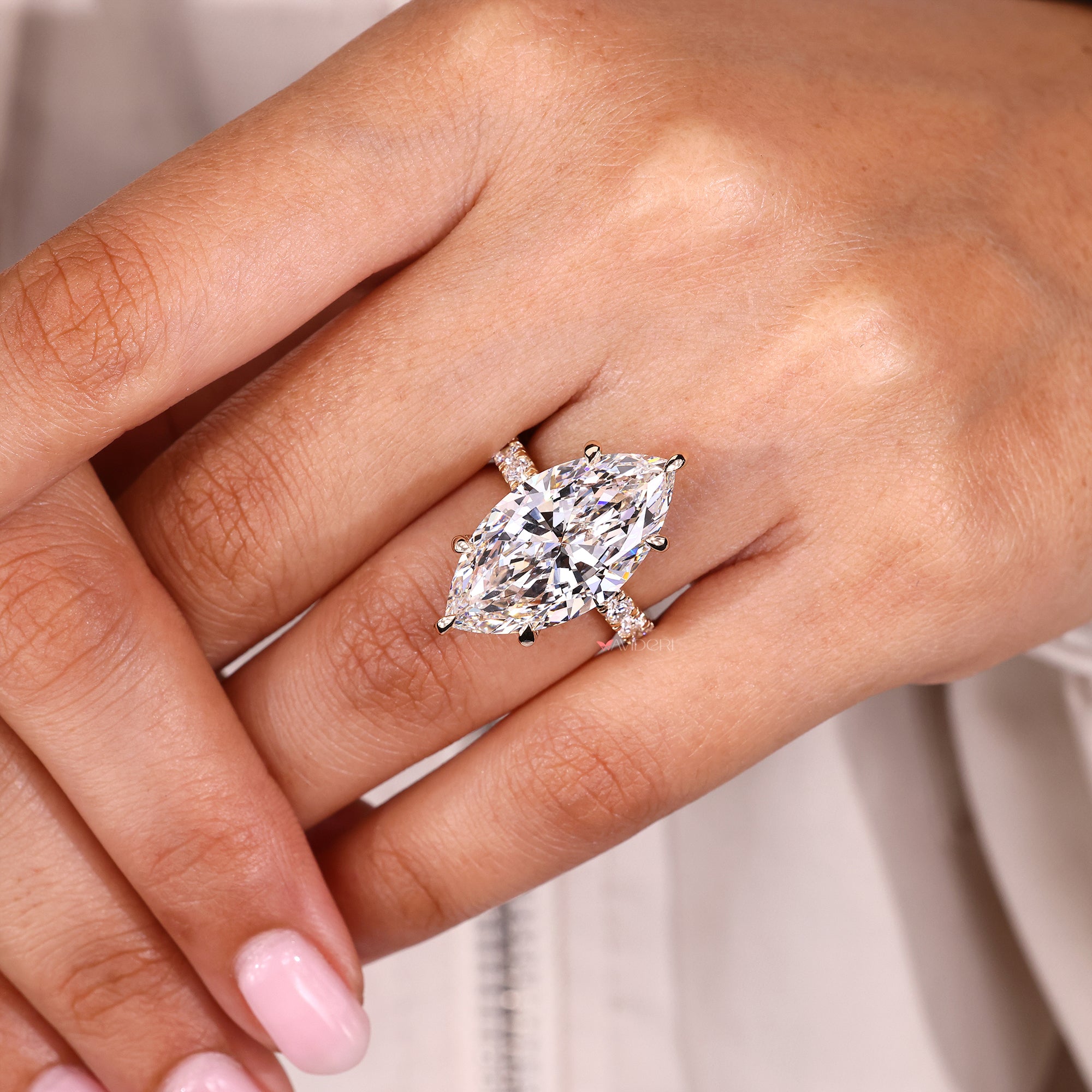 Hidden halo engagement ring with six claw prong set.