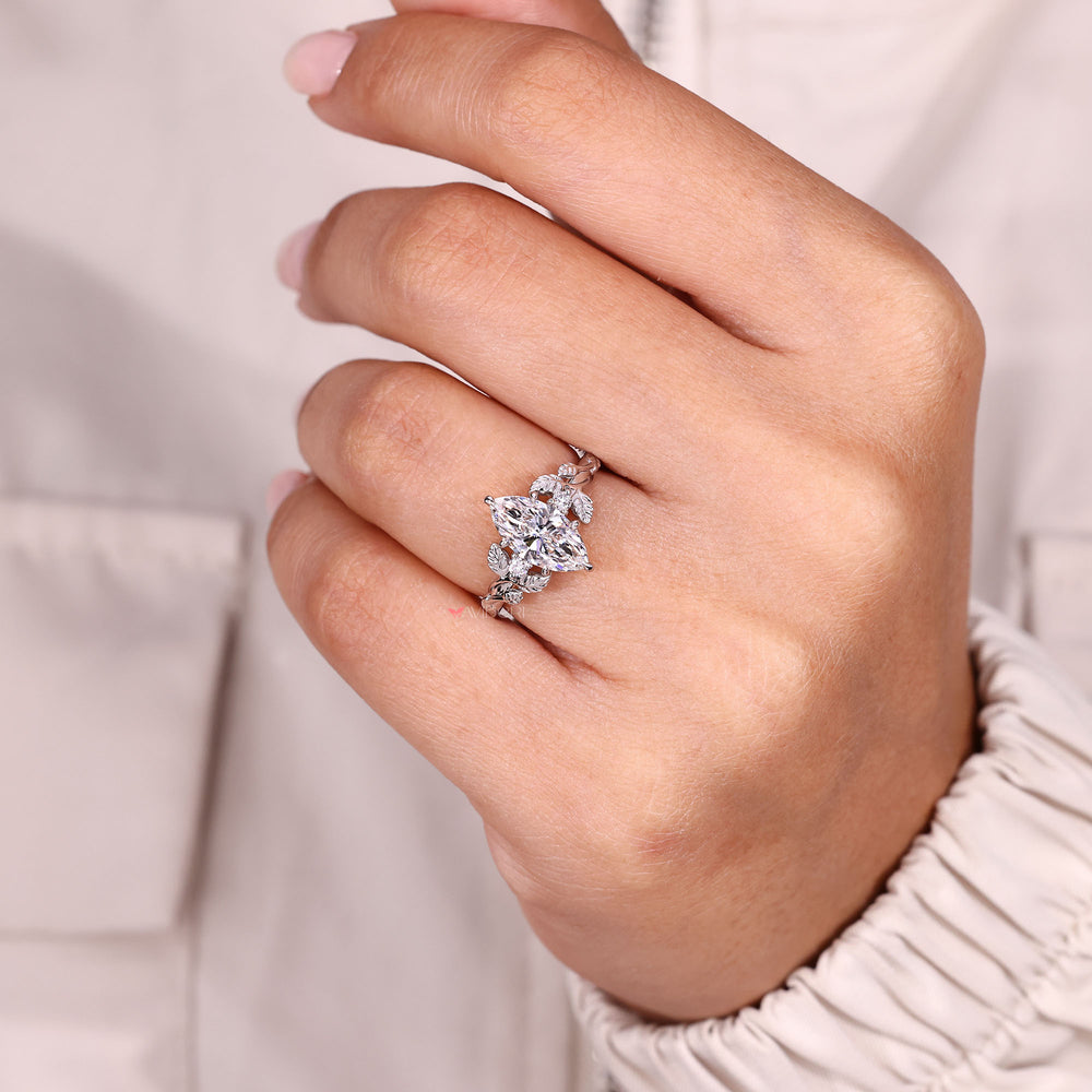 Marquise diamond ring with round accents.
