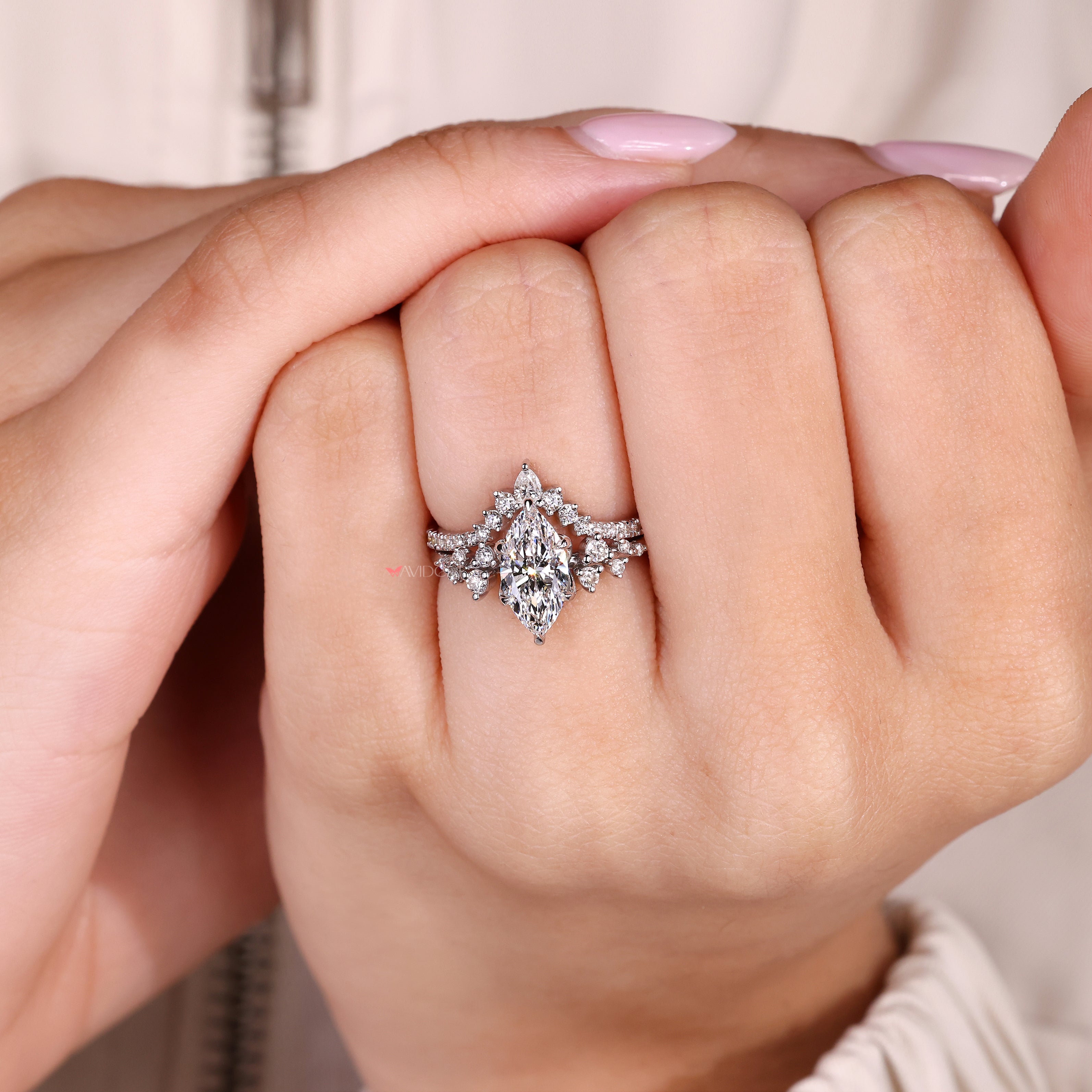Marquise ring set with pear diamonds and curved band

