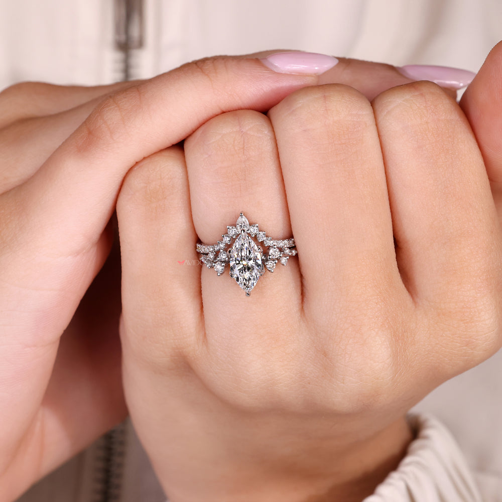 Marquise ring set with pear diamonds and curved band
