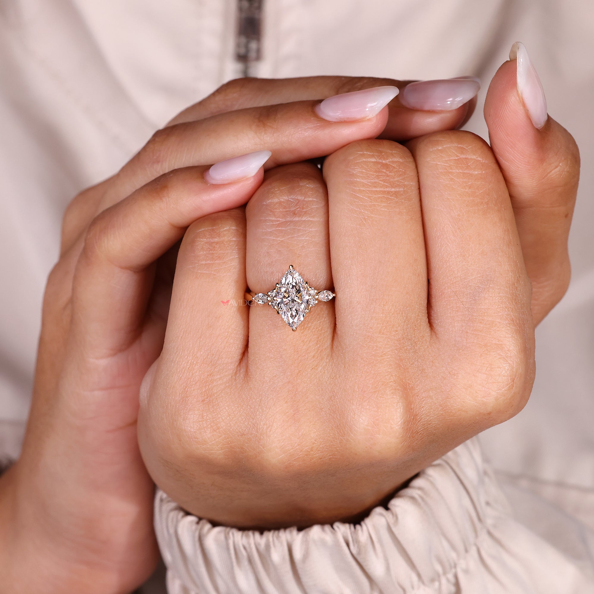 Marquise cut diamond ring with six claw prongs.
