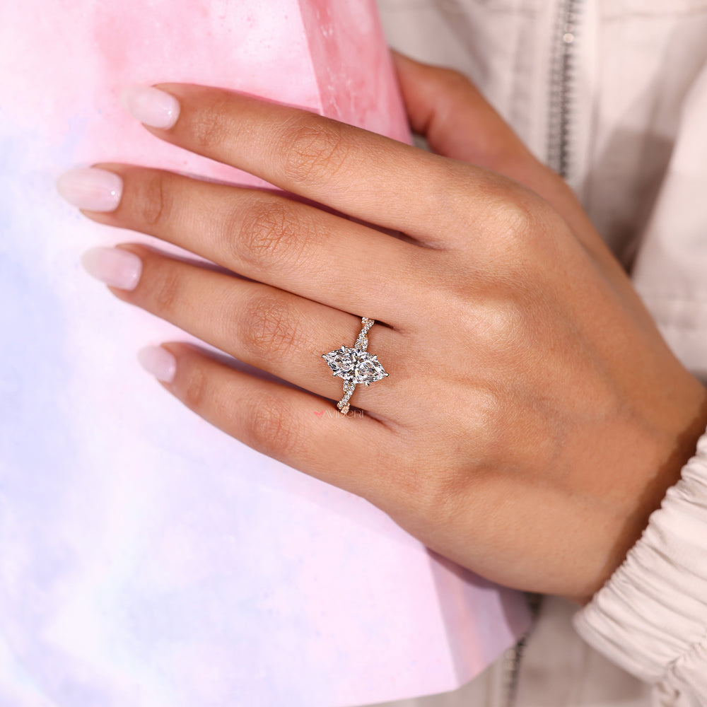 Hidden halo marquise diamond ring with twisted pave band.
