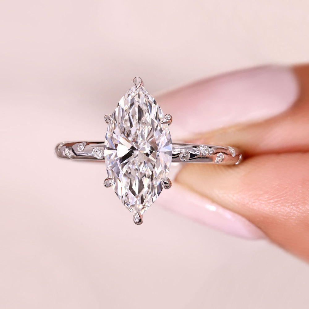 Marquise cut diamond ring with six claw prong setting.
