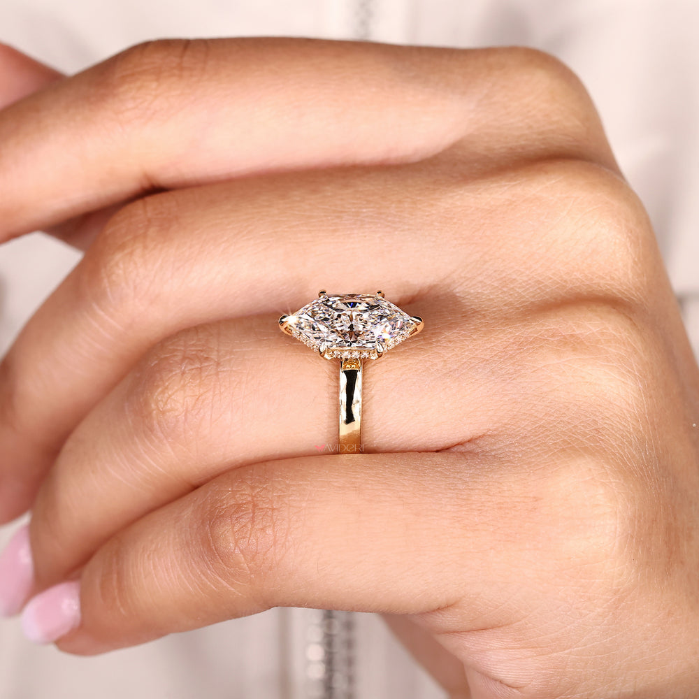 Dutch marquise diamond ring with round hidden halo accents.