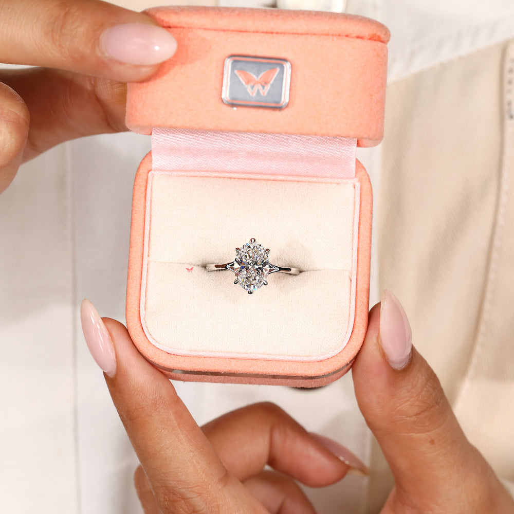 Handmade oval diamond ring with claw prongs.
