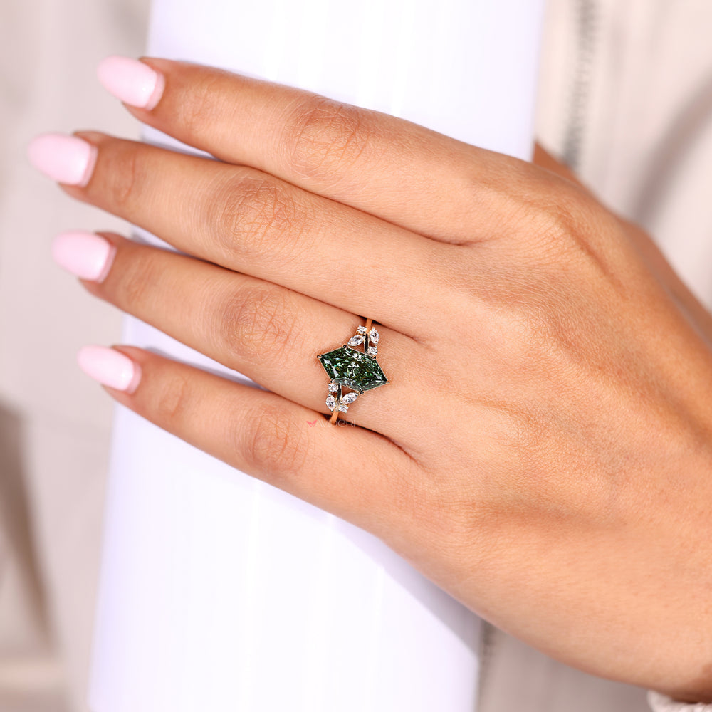 Split shank diamond ring with green center and accents
