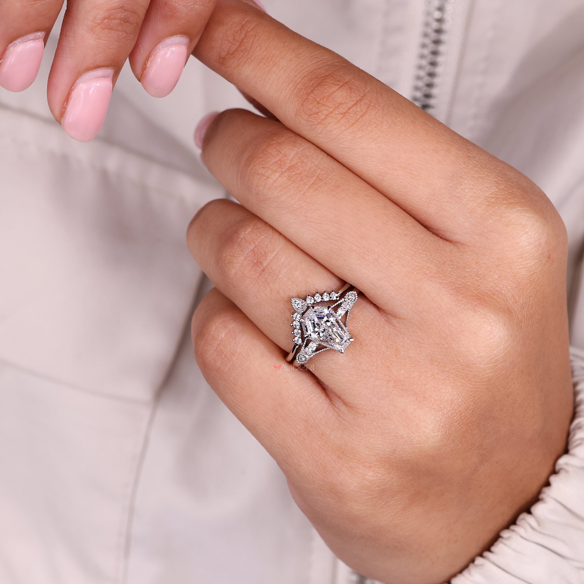 Round side stone engagement ring with milgrain details.