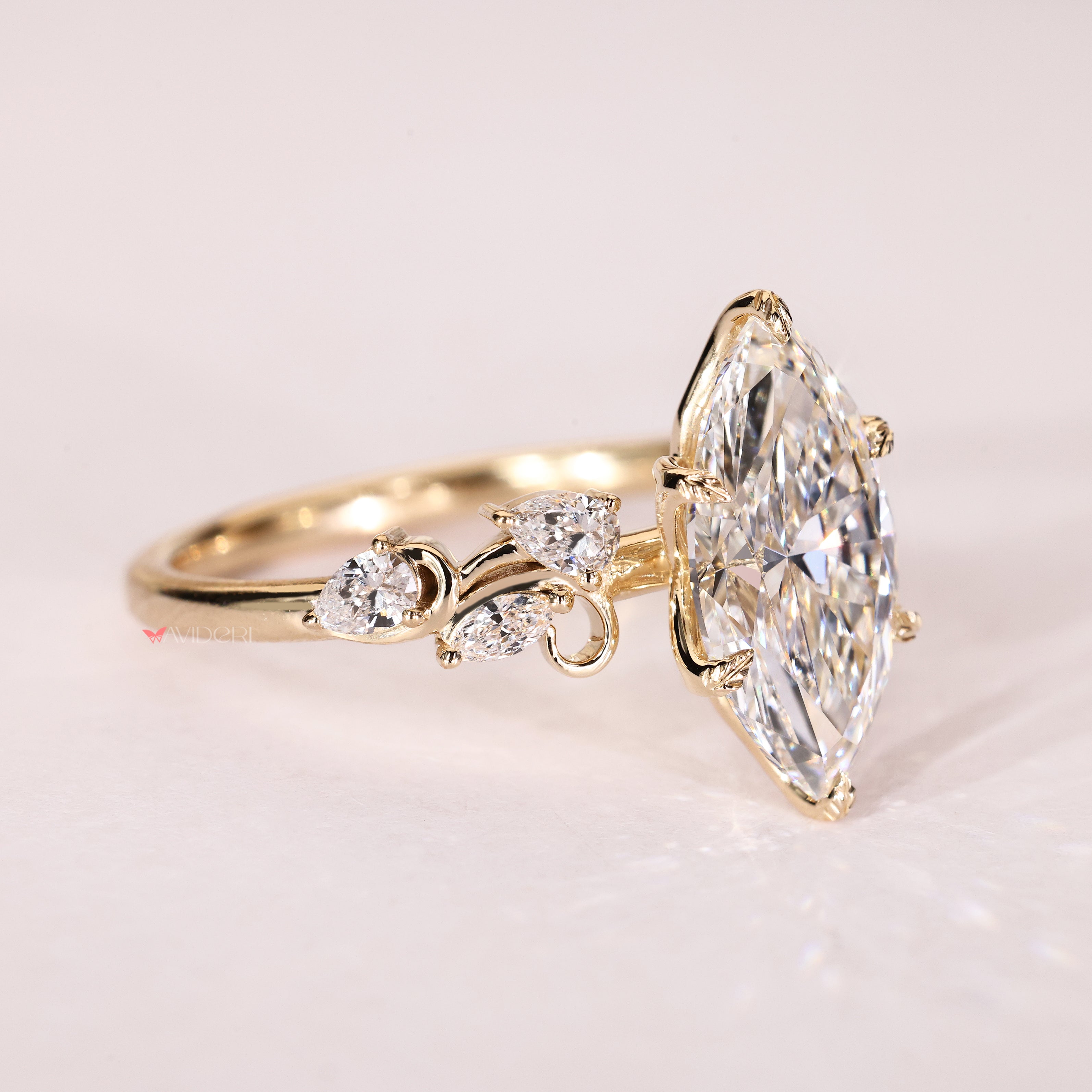Marquise lab diamond ring with pear accents and tulip setting
