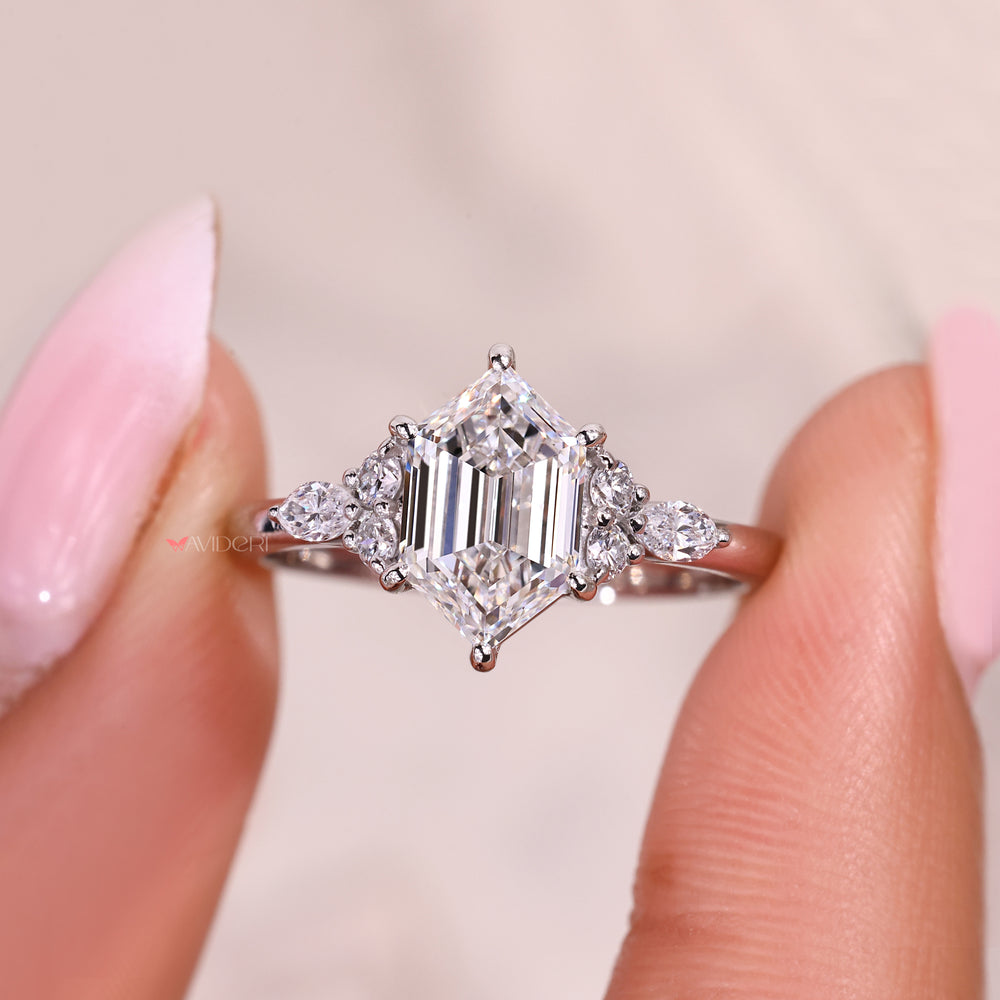 Seven stone ring with hexagon step cut and round stones.