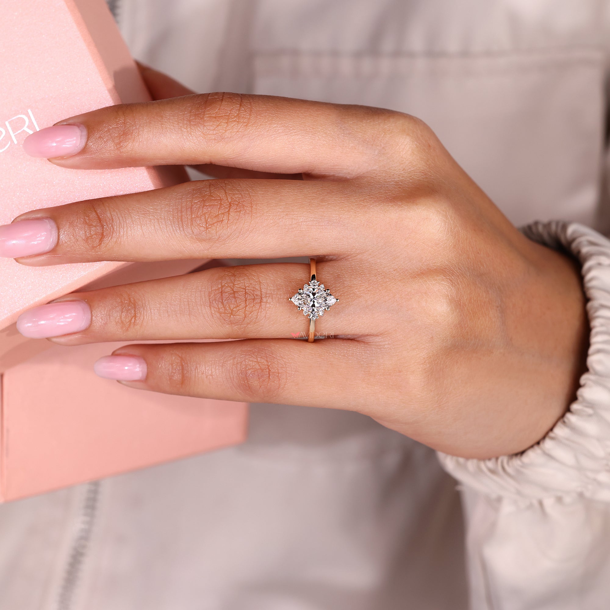 Marquise cut ring with muse setting and seven stone design.
