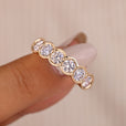 Bezel set wedding band with round lab grown diamonds.
