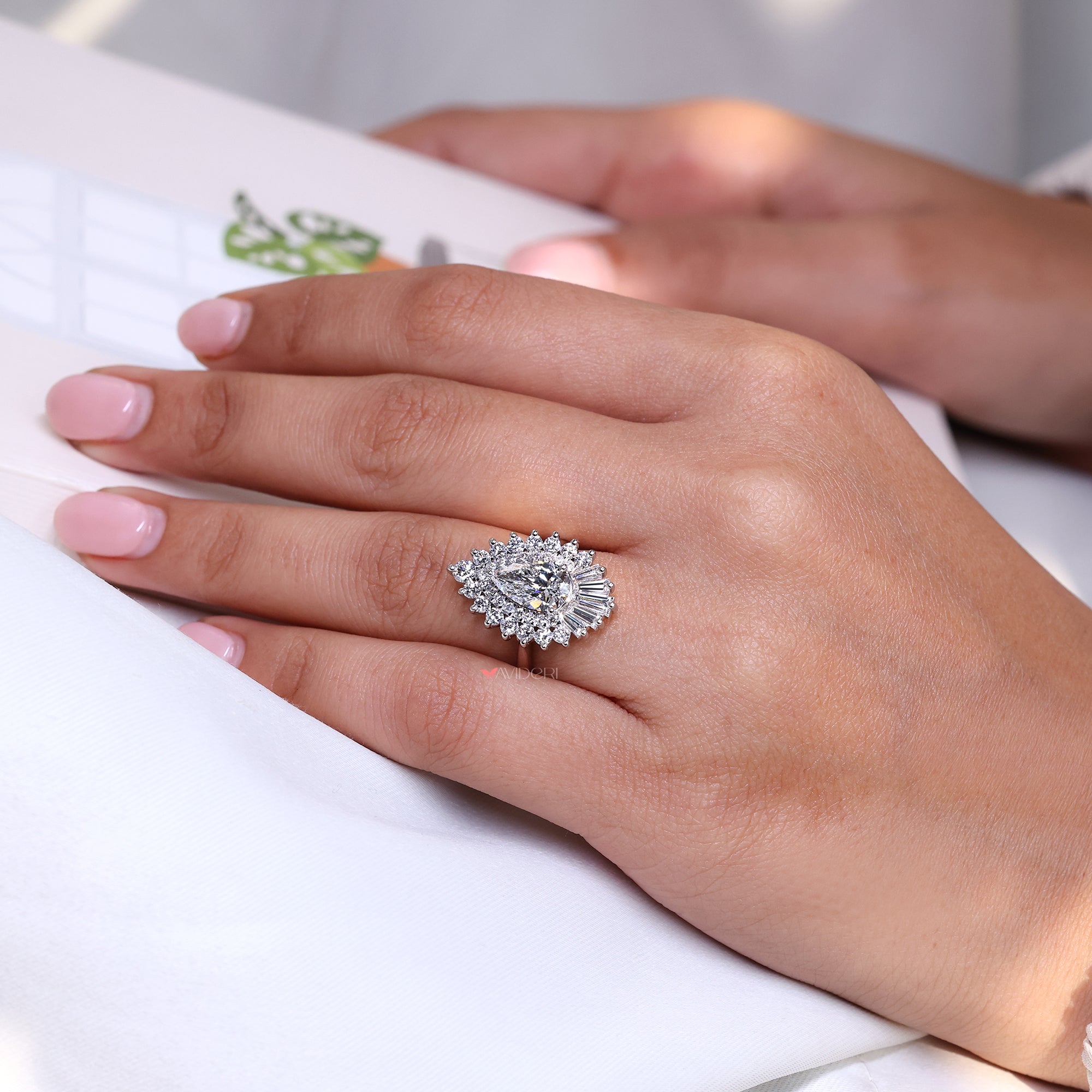 Tapered baguette and round side stone on vintage engagement ring.