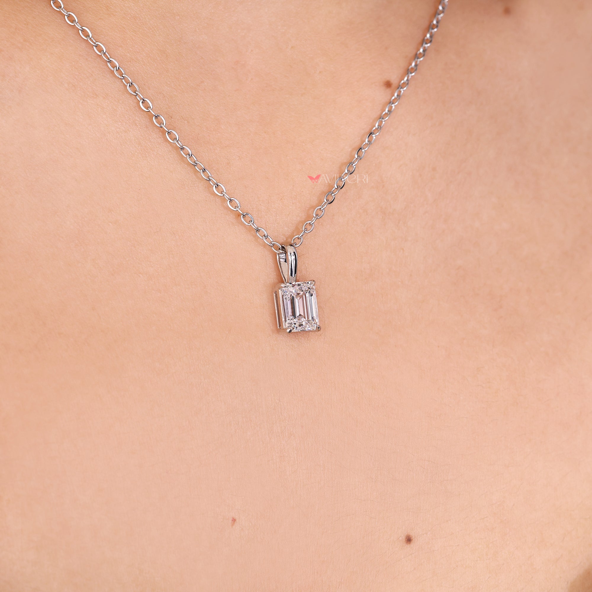 Emerald solitaire pendant as part of handmade jewelry designs.