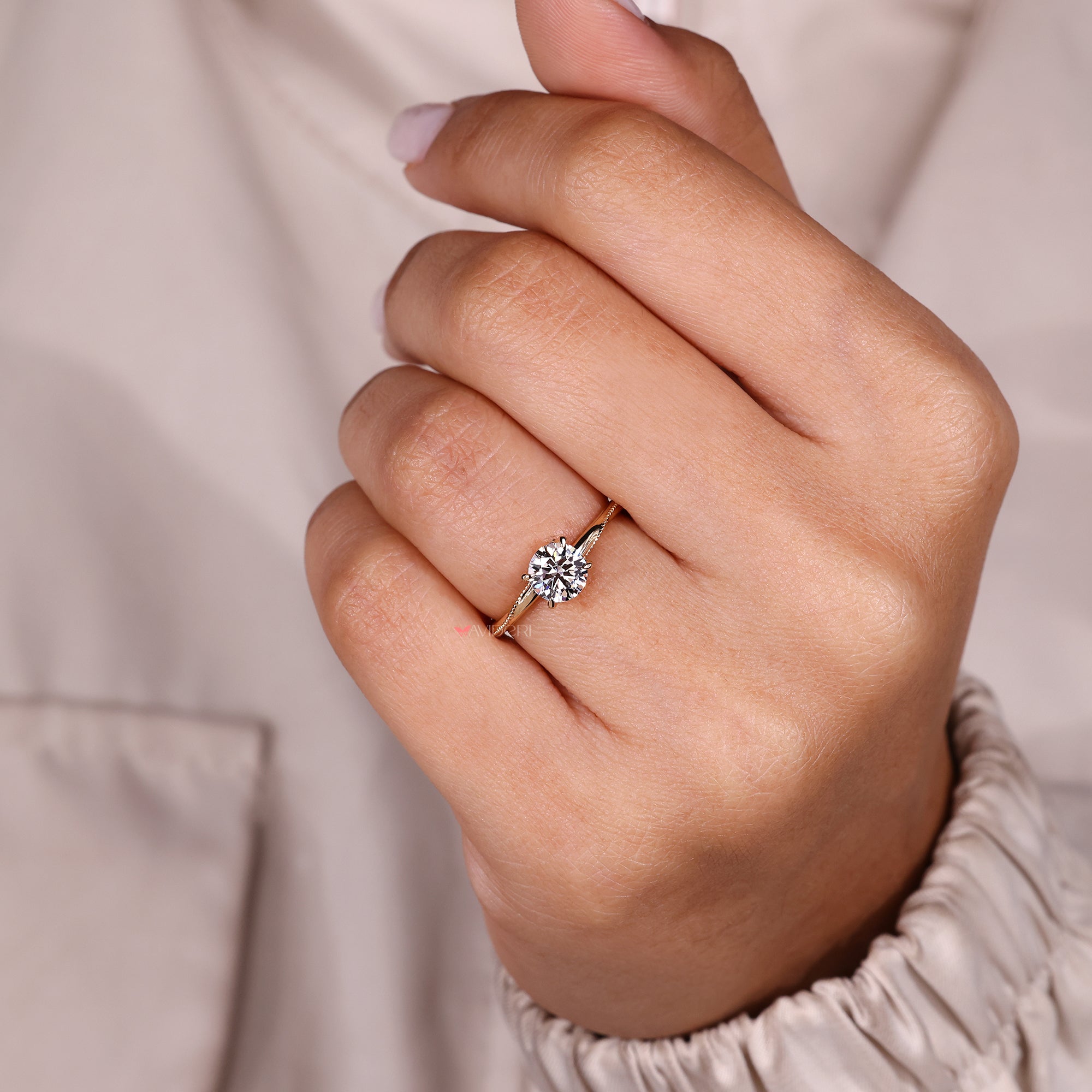 Round cut diamond ring with elegant milgrain details.
