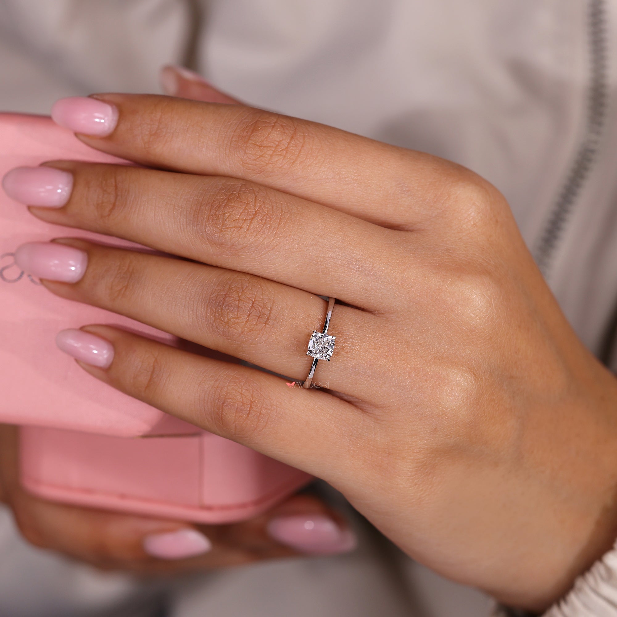 Cushion cut ring with four claw prong setting.