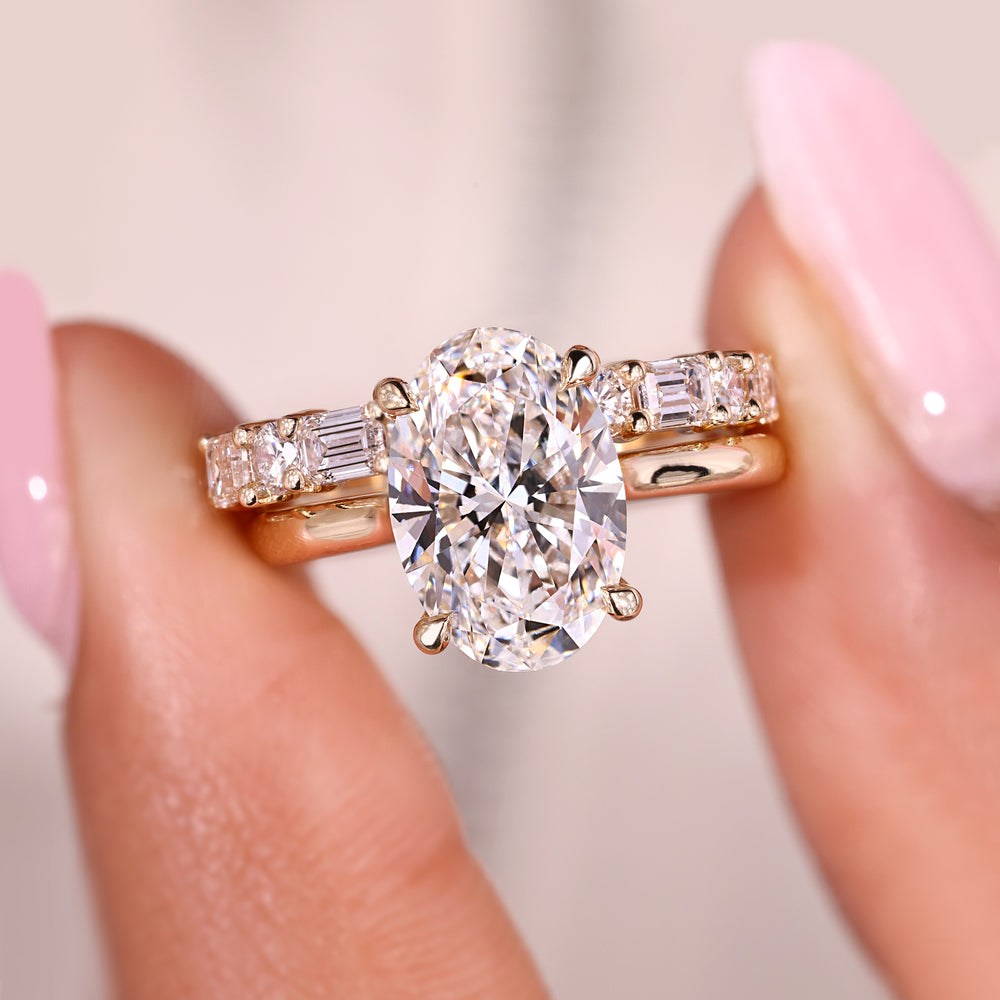 Handmade oval diamond ring with solitaire and diamond band.