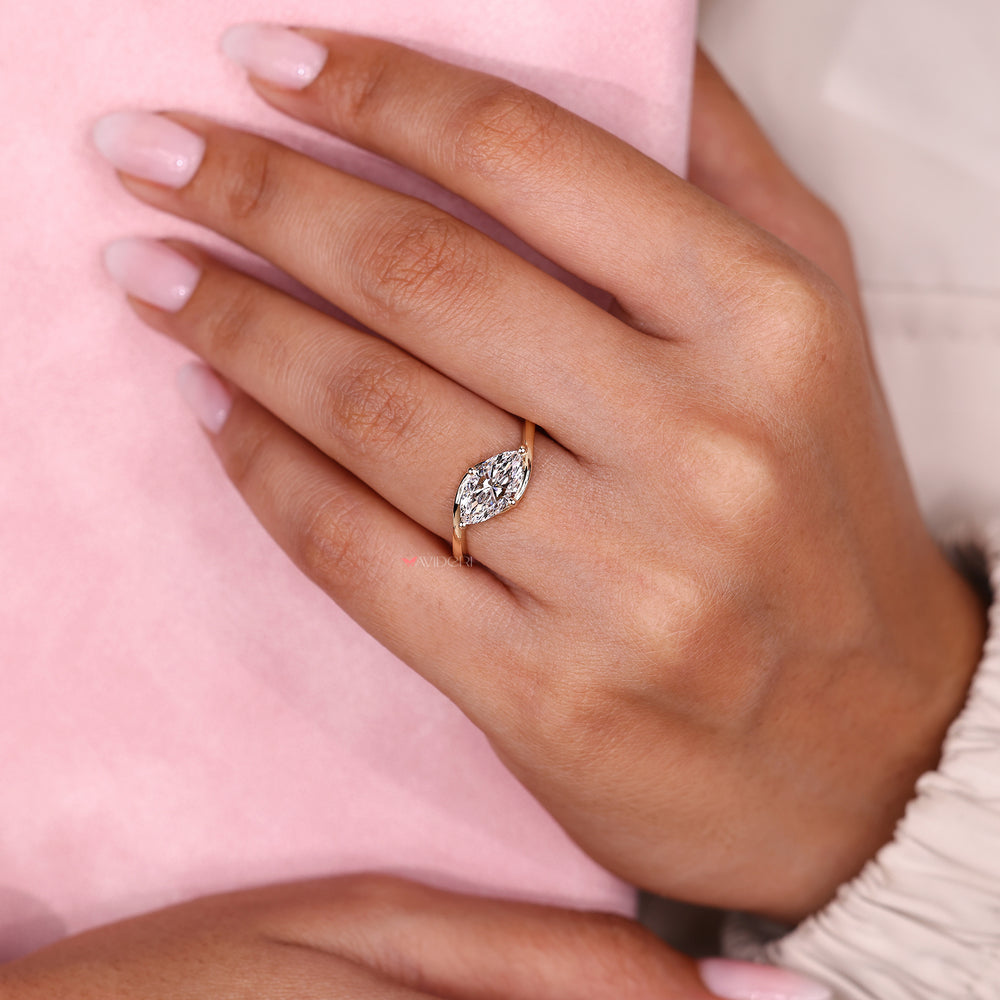 Marquise solitaire engagement ring with prong.
