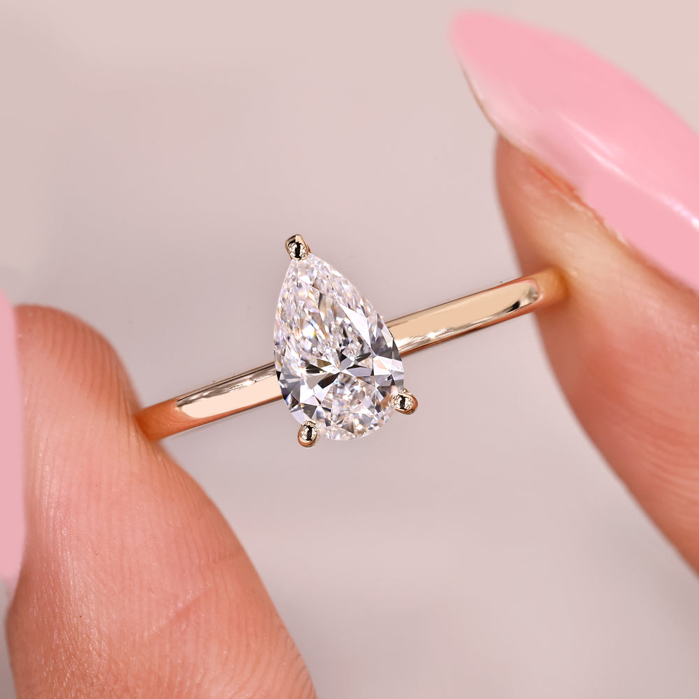 Minimal pear cut diamond engagement ring.
