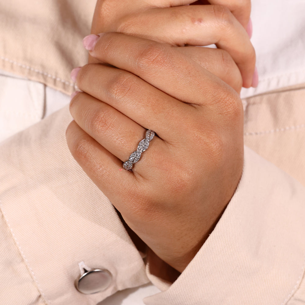 Diamond twist wedding band with alternating diamonds.

