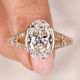 Oval diamond engagement ring with cathedral setting ring.