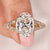 Oval diamond engagement ring with cathedral setting ring.
