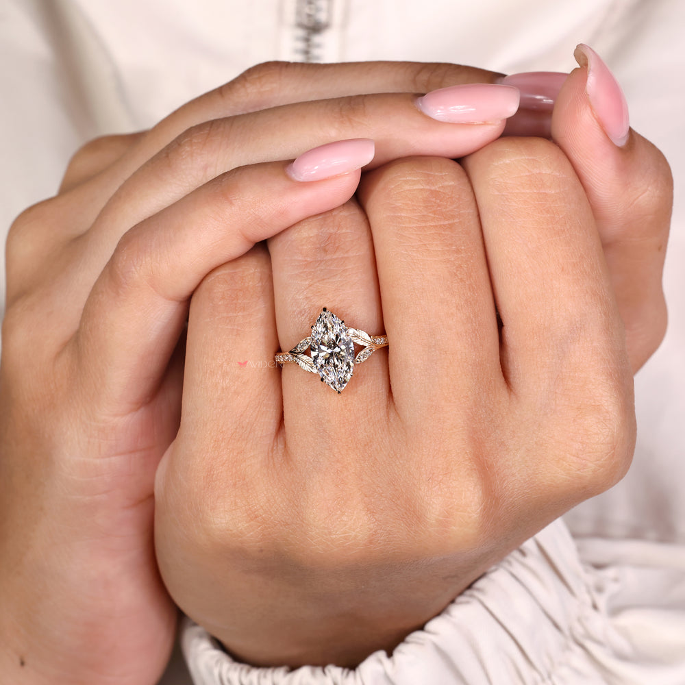 Marquise center diamond ring with pave set round diamonds
