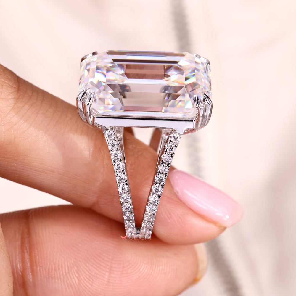 Split shank emerald cut ring with round moissanites.