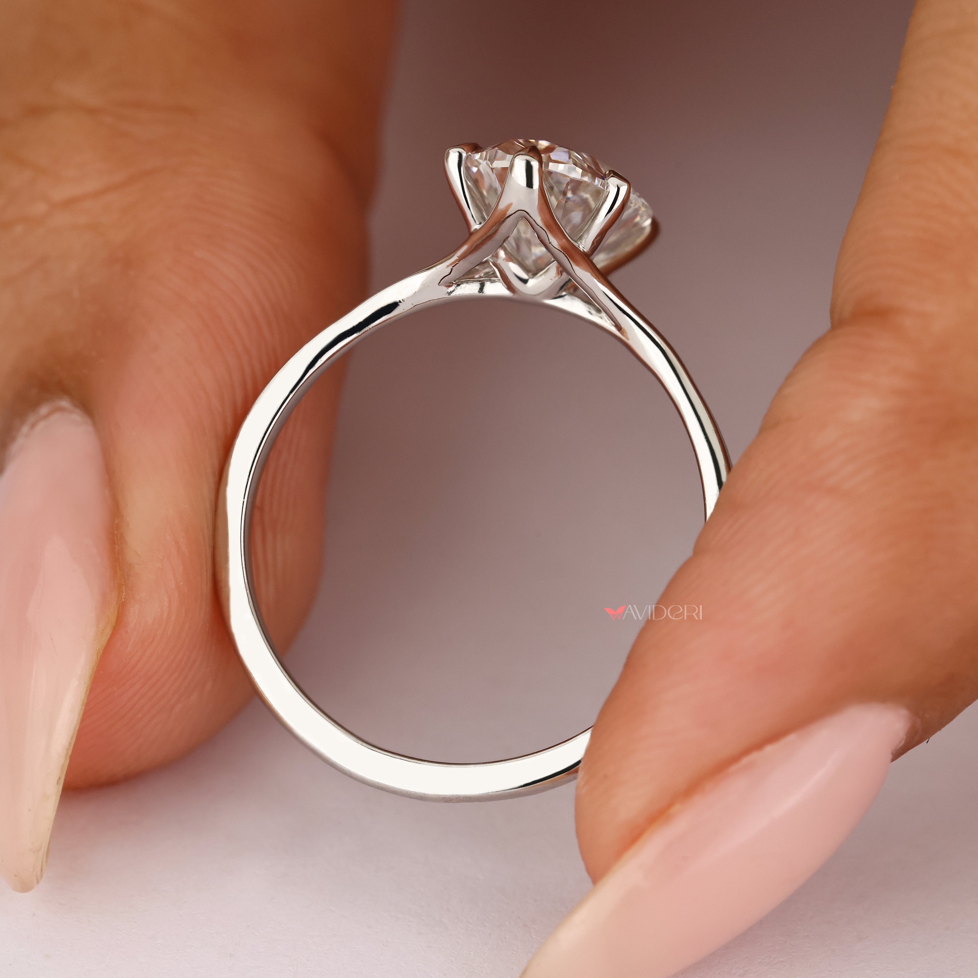 Oval diamond solitaire ring with split shank.
