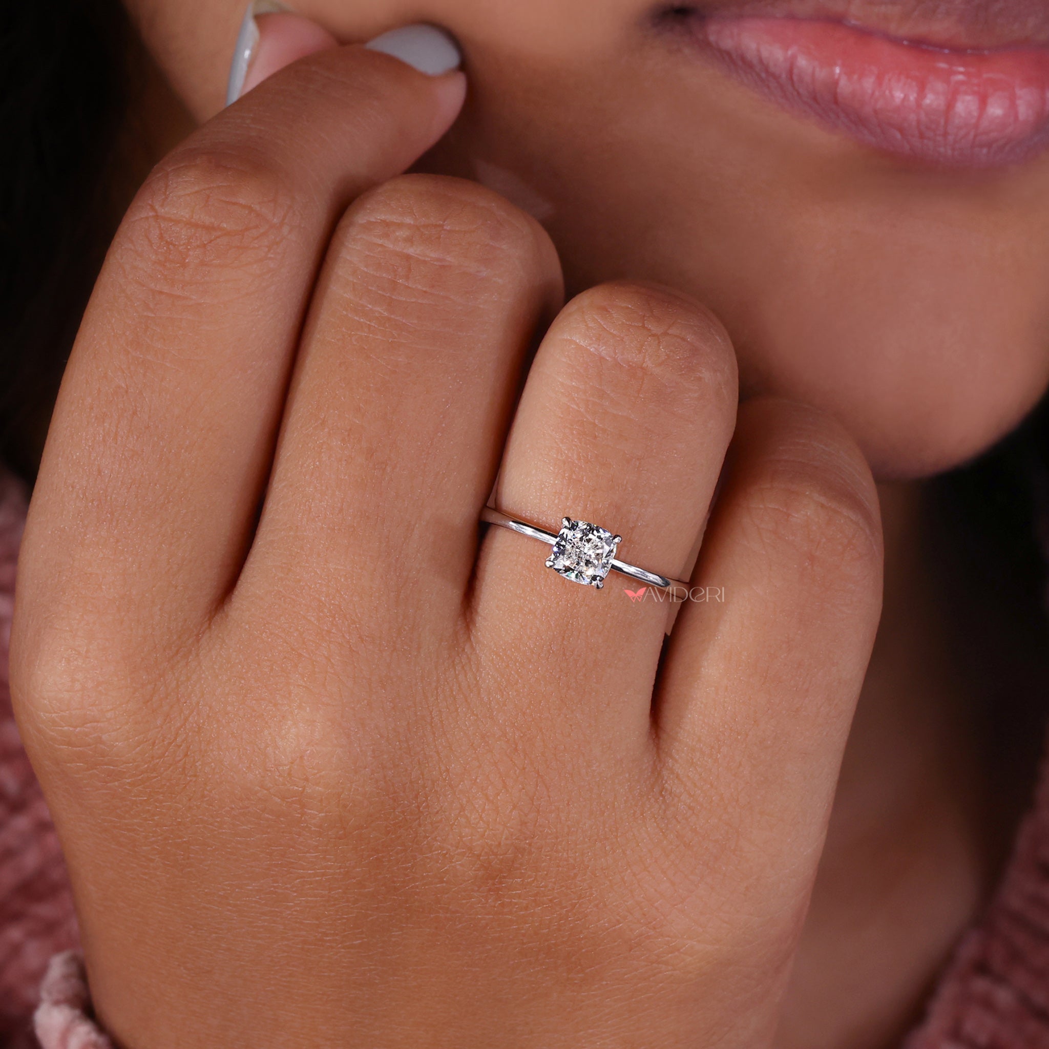 Cushion solitaire engagement ring with claw prong setting and igi certified diamond.

