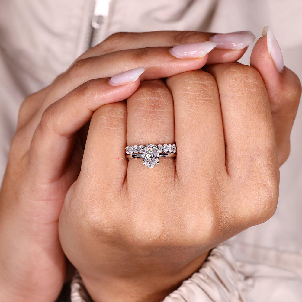 Oval cut solitaire ring with half eternity band.
