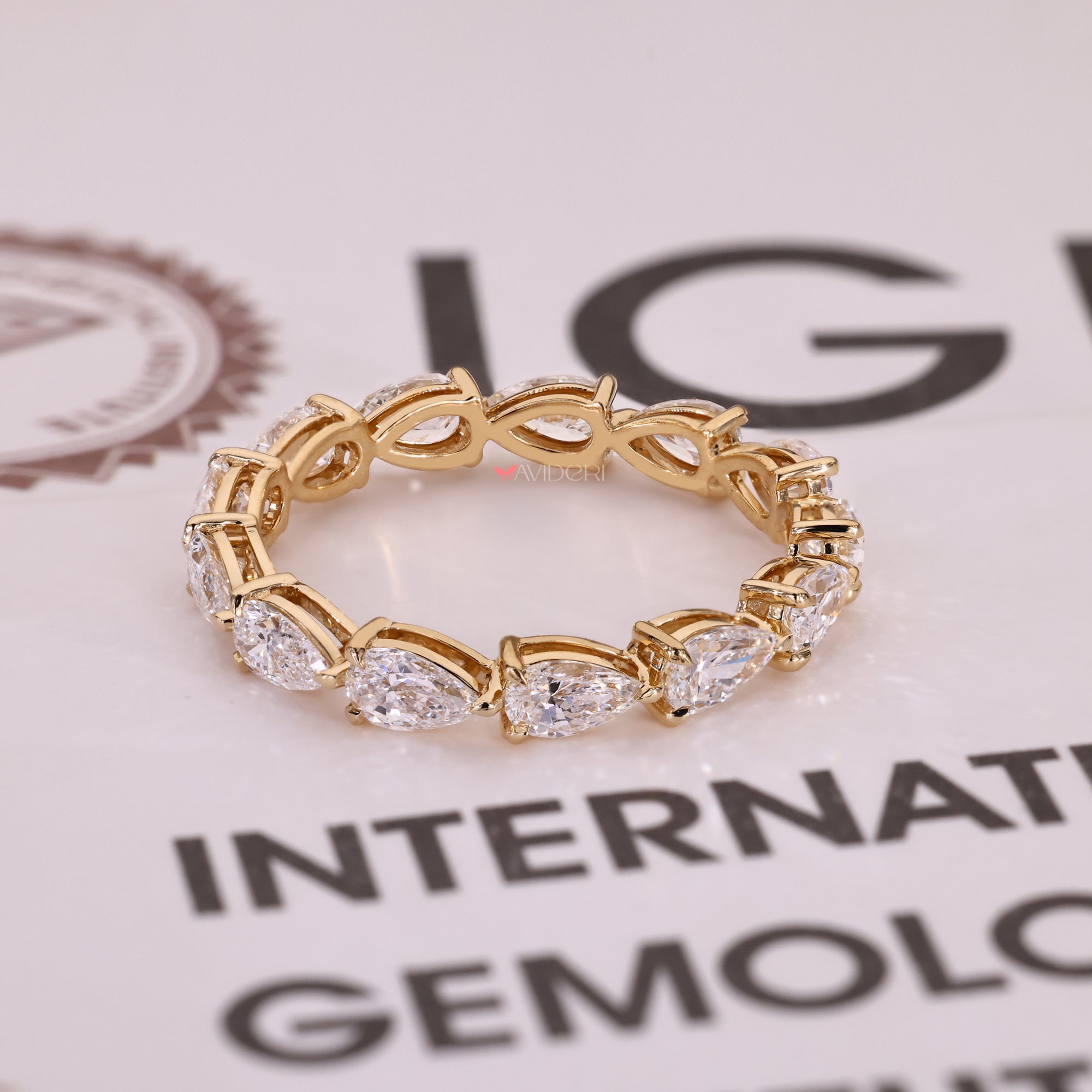 Pear cut diamond stackable eternity band in prong setting.
