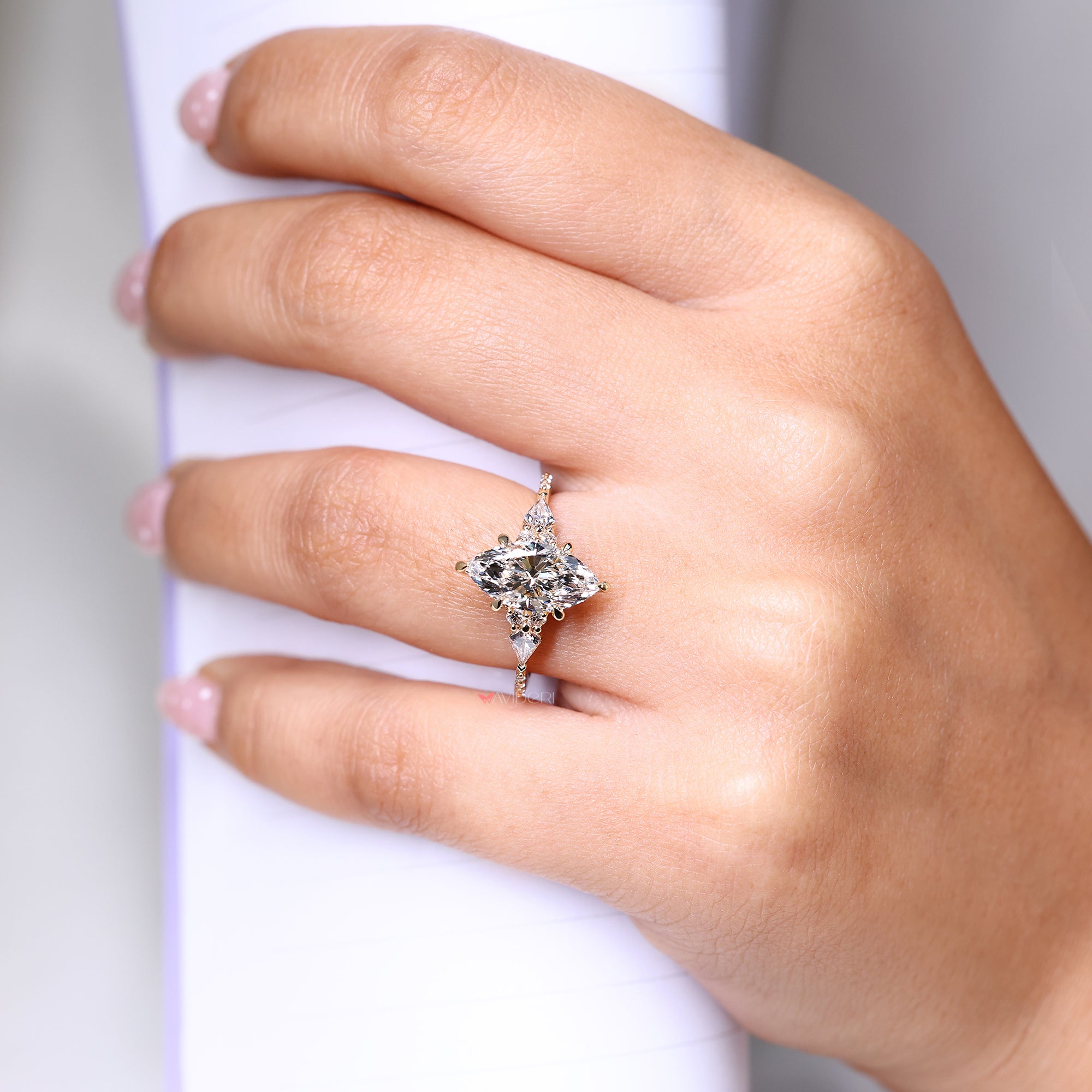 Kite and round cut side stone in yellow gold engagement ring.