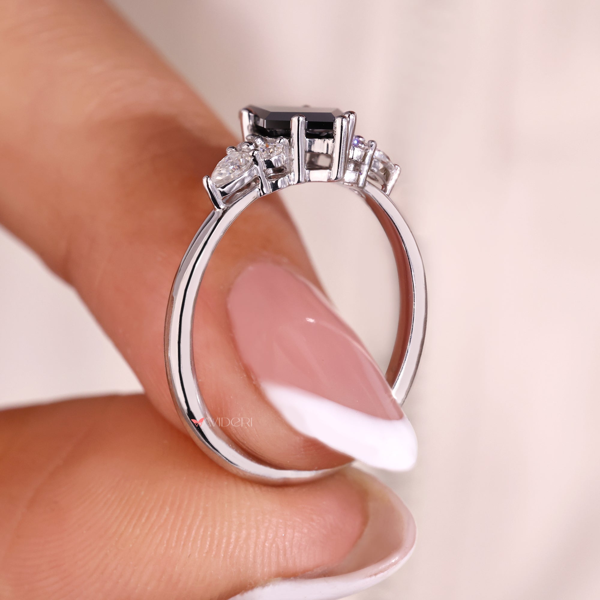 Side stone engagement ring with tapered shank ring style.