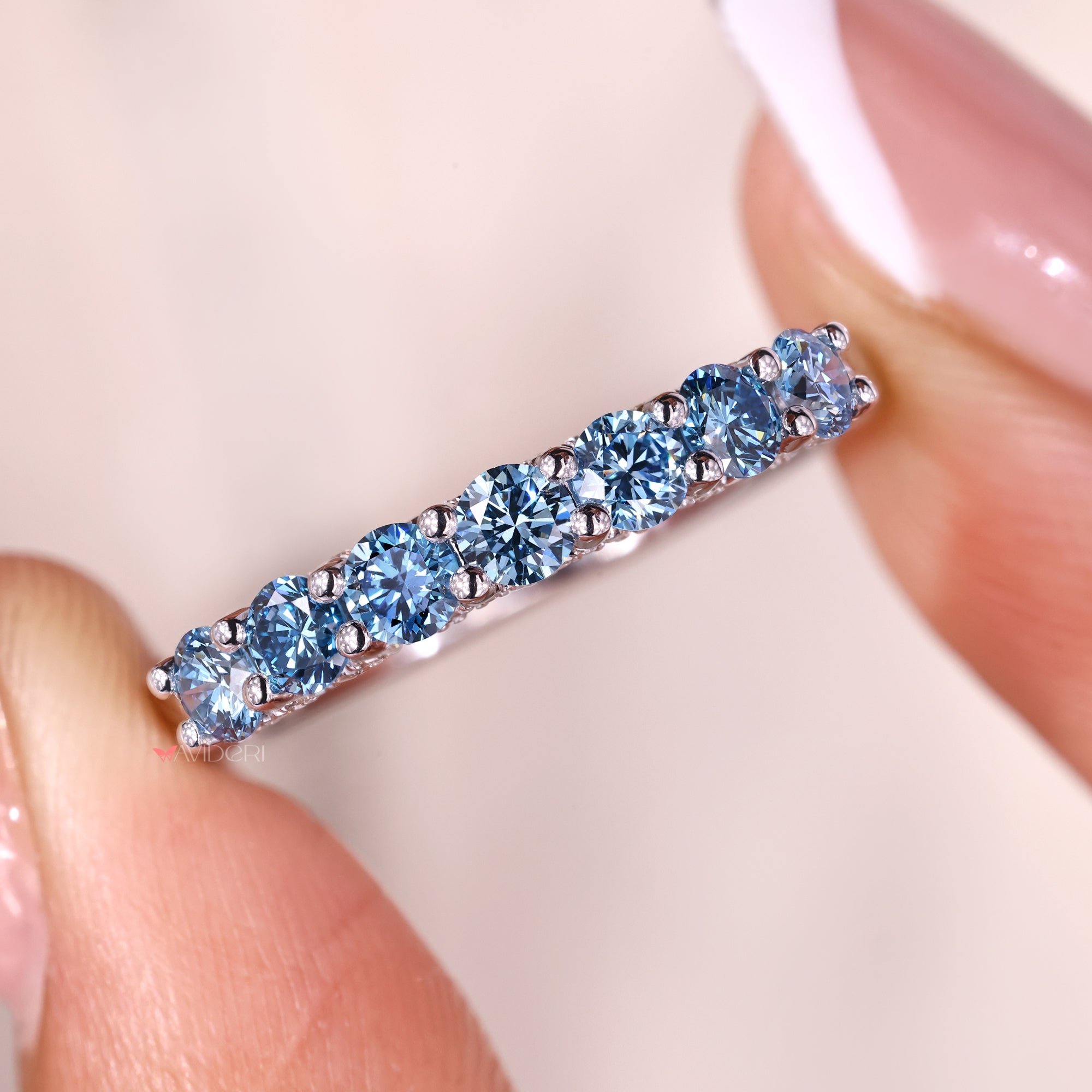 Shared prong setting with blue diamond wedding band.