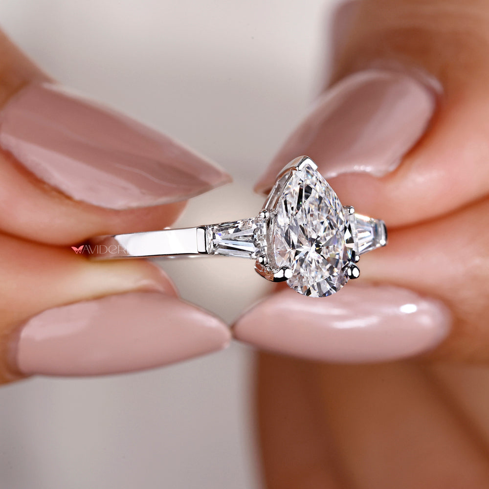 Pear shape diamond ring highlighting a classic pear-shaped center stone, ideal for engagements and special occasions.

