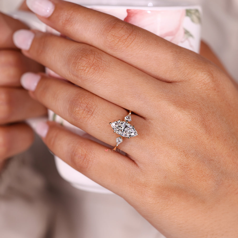 Three stone marquise diamond ring with tapered shank.