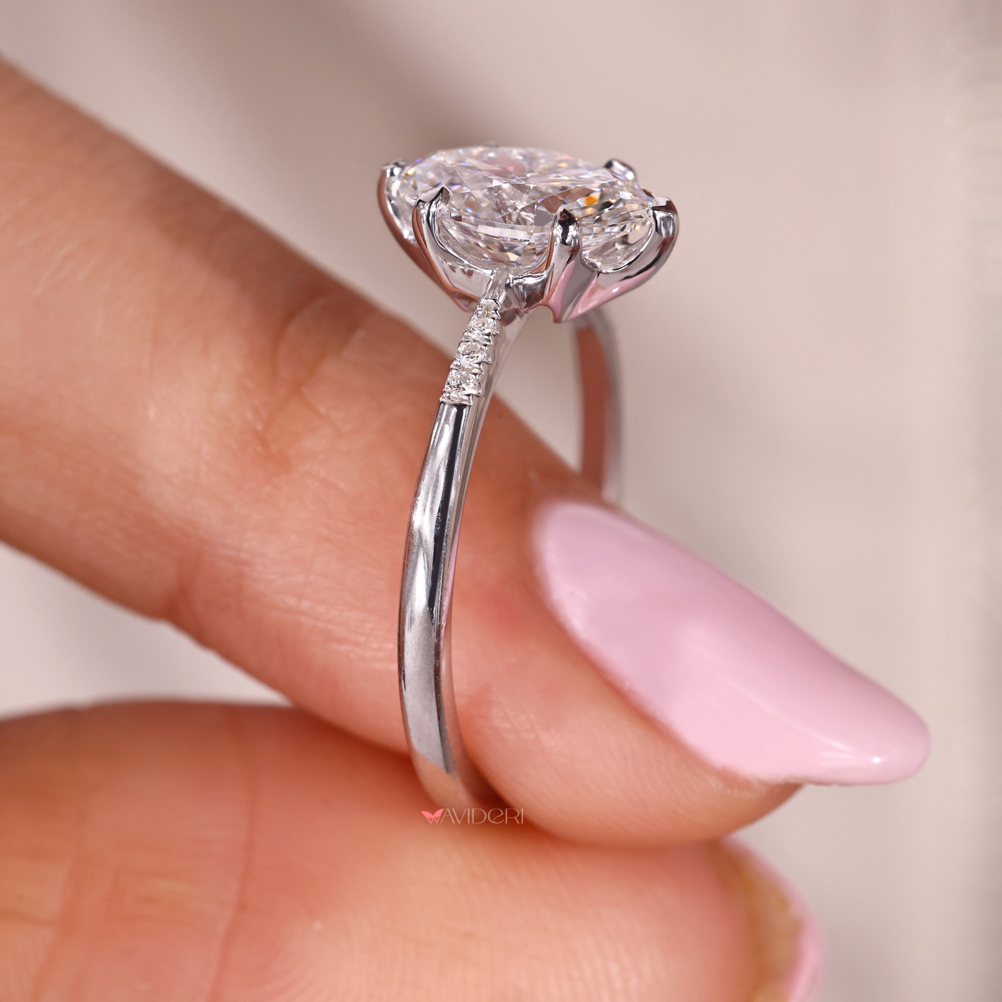 White gold ring with oval and round diamonds.