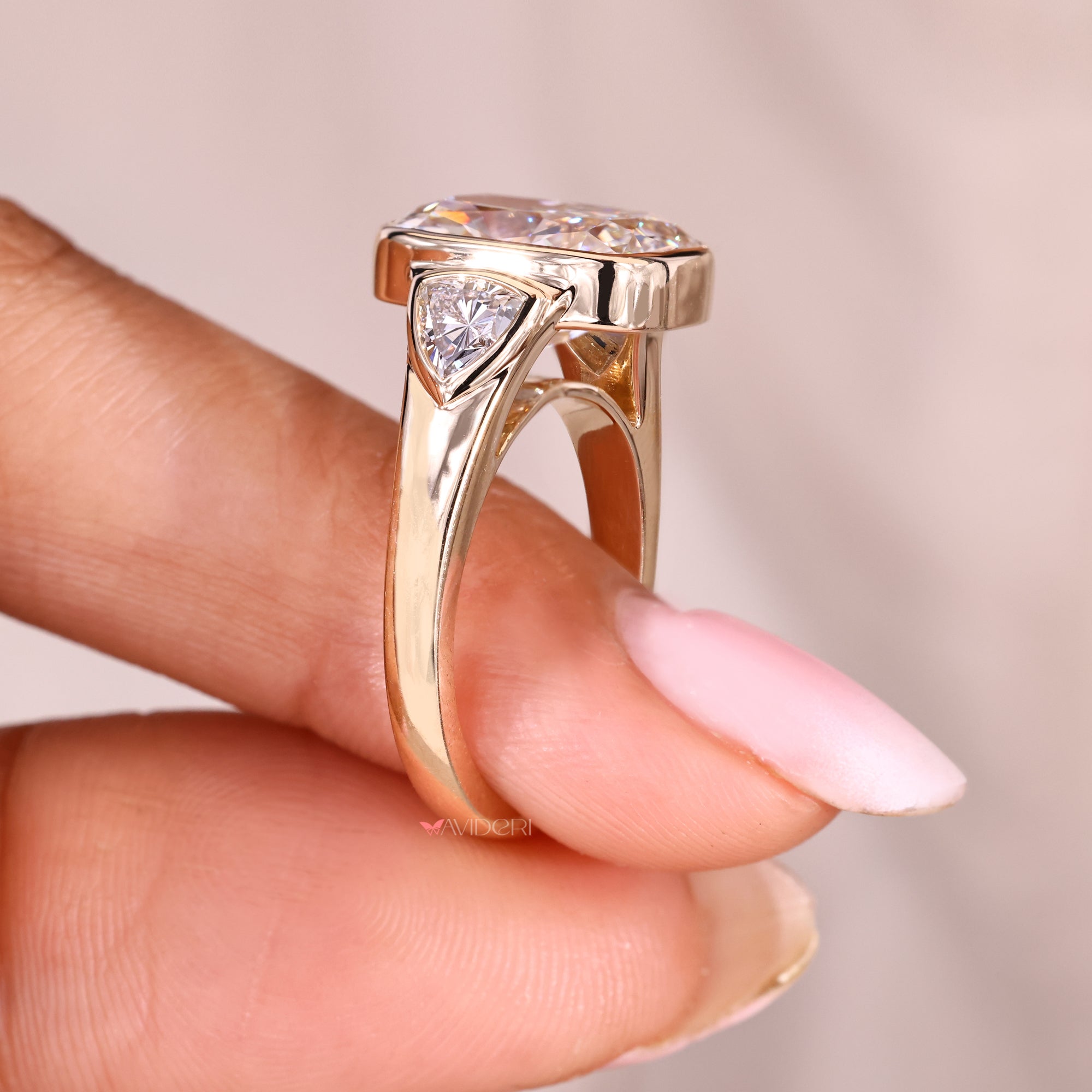 Three stone cushion cut diamond ring with tapered shank.