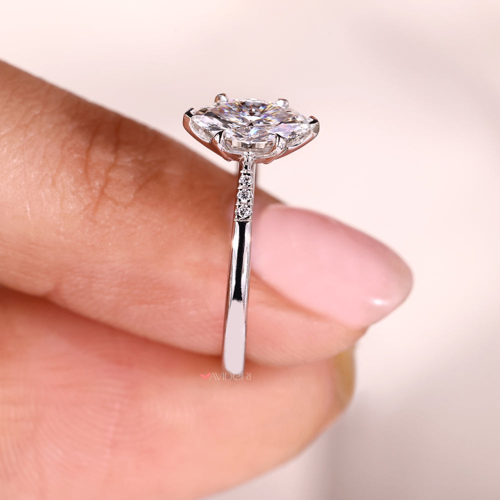 Tapered shank ring with marquise diamond and round side stones.