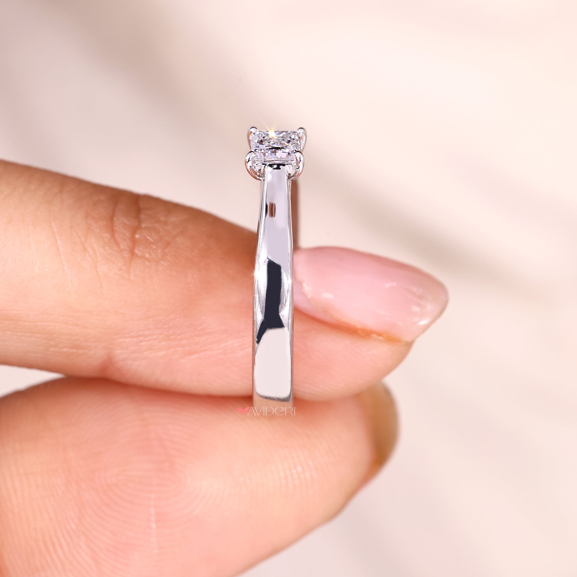 Tapered shank ring with four prong setting.